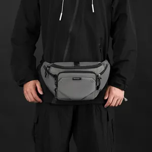 Water-resistant gray sports waist bag for outdoor casual wear featuring a zipper compartment