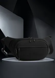 Detail of multi-pocket black outdoor sling bag with textured fabric and zipper compartments