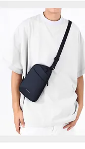 Close-up of lightweight black crossbody bag with adjustable strap and front zipper