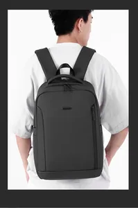 Detailed back view of a men's black business backpack on model showing padded straps