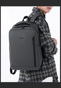 Close-up of deep grey business backpack with waterproof fabric and metal logo detail