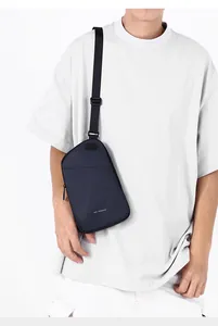Close-up of lightweight navy blue crossbody chest bag with adjustable strap and print