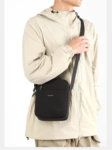 Outdoor leisure crossbody bag worn by a model in a beige jacket for daily commute