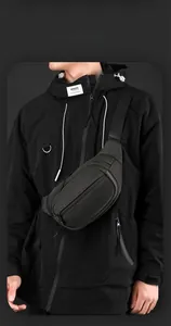 Detail of black tactical chest bag with textured mesh fabric and multi-layer zippers