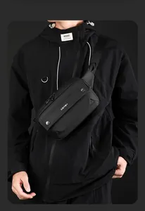 Close-up of minimalist black waterproof chest bag with multiple zipper compartments