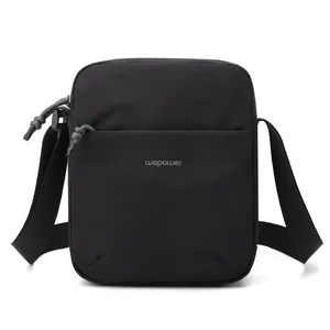 Minimalist black nylon crossbody bag for travel and daily commute with adjustable strap