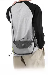 Macro view of water-resistant gray checkered crossbody bag with adjustable strap
