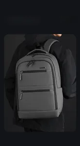 Close-up of waterproof dark gray business backpack with side pockets and smooth zippers