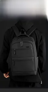 Ergonomic shoulder straps and thick handle on a black water-resistant business backpack