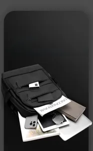 Detail showing high-capacity interior of black laptop backpack with organized storage compartment