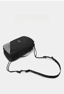 Detail of grid texture crossbody bag with rope strap and geometric logo on surface