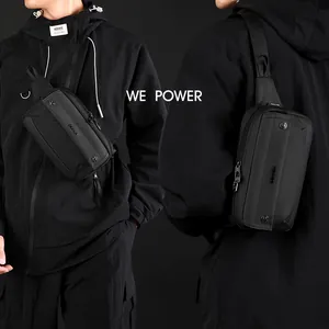 Waterproof black nylon chest bag with metallic studs worn by a model in urban style