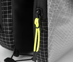 Detailed close-up of gray ripstop fabric and zipper with neon yellow pull cord