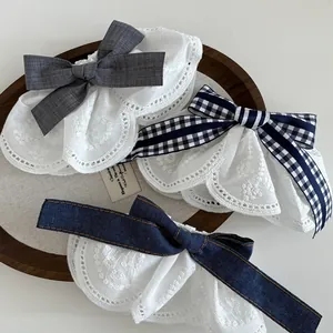 Detail of three-piece lace bow hair clips featuring navy plaid and denim textures