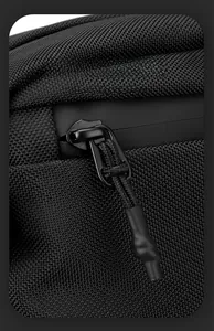 Close-up of waterproof zipper and metal puller on black nylon motorcycle messenger bag