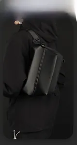 Detail of waterproof black crossbody bag with adjustable strap and smart storage space