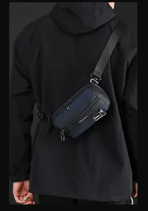Rear view of deep blue nylon chest bag with plastic buckle and metal zipper details