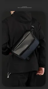 Navy nylon messenger bag with adjustable strap and waterproof finish on a male model