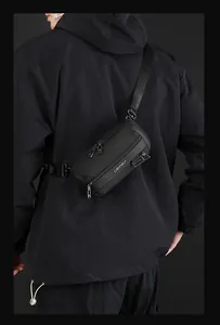 Detail view of durable black nylon crossbody bag with multiple zippers and quick-release buckle