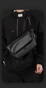Detail of black tactical messenger bag with adjustable strap and brand logo print
