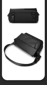 Detail of black waterproof crossbody bag featuring adjustable straps and buckle closures