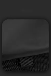 Detail of waterproof matte fabric and woven strap on a black tactical messenger bag