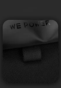 Close-up of waterproof fabric texture and brand logo detail on black messenger bag