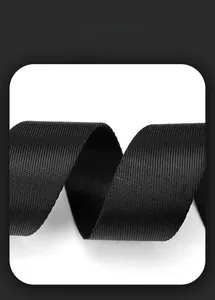 Detail of high-density black nylon webbing with twill weave on a motorcycle messenger bag