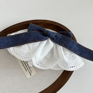 Classic dark blue denim and white lace bow hair clip with vintage label detail