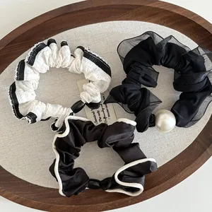 Three-piece set of elegant lace hair scrunchies with pearls in black and white styles