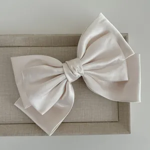 Elegant cream satin triple-layered bow hair clip with luxury silk texture finish