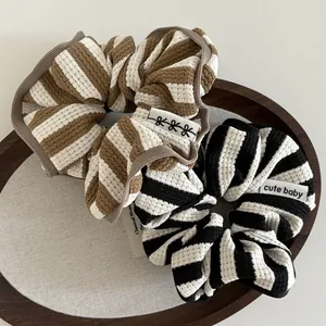 Waffle knit striped hair scrunchies set in brown and black with cute baby label