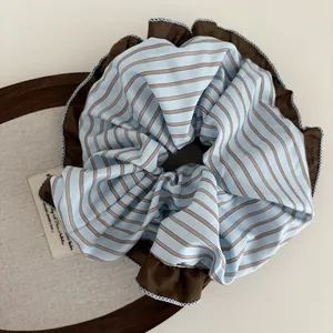 Chic blue and brown striped oversized scrunchie with ruffled trim for ponytail styling