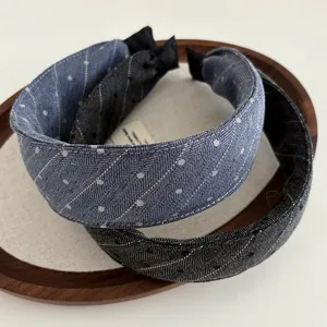 Detail of wide padded headbands in light blue and dark grey with textured denim fabric