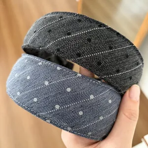 Detail of wide denim padded headband with white contrast stitching and polka dot pattern