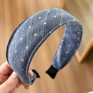 Detailed close-up of blue polka dot denim headband featuring wide retro sponge design