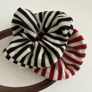 Macro view of knitted striped scrunchies showing detailed soft woven texture