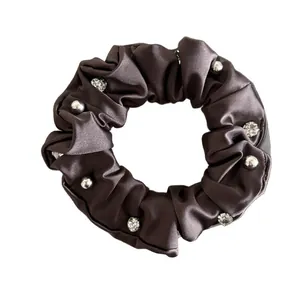Brown satin scrunchie with silver studs and crystals shown on a clean white background