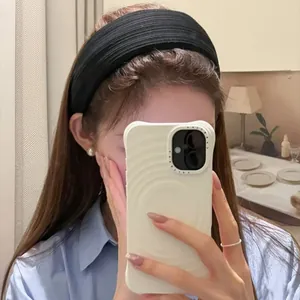 Detail showing a wide black headband with fine vertical textures worn by a model