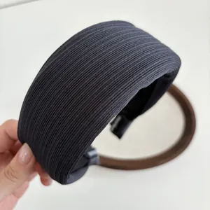 Detail of grey wide padded headband featuring pleated texture and elegant fabric