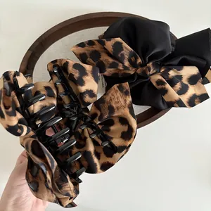 Large leopard print bow hair claw clips with black plastic teeth for elegant hair styling