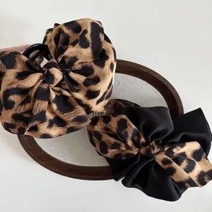 Large leopard print bow hair claw clip with satin finish for elegant women hairstyles