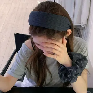 Chic Morandi dark grey wide headband with ribbed texture worn in a natural setting