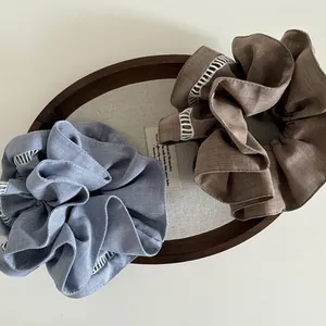 Close-up of elegant double-layered lace scrunchies in blue and brown fabric textures