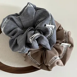Two-piece large fabric scrunchies with white openwork crochet lace and cute baby labels