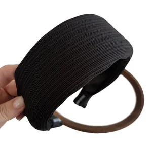 Wide black headband with vertical ribbed texture shown from an angle on white background