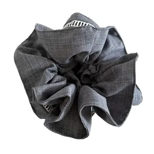 Elegant charcoal grey ruffled fabric scrunchie with white lace trim for ponytails
