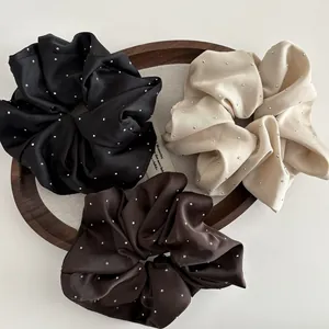 Three satin scrunchies in black, apricot and coffee with sparkling silver rhinestones