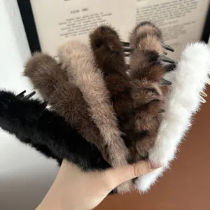 Detail of plush faux fur hair claws in black, brown, and tiger print with soft texture