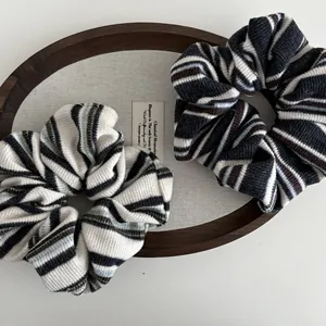 Detailed macro view of soft knit striped scrunchies with elegant textured fabric patterns